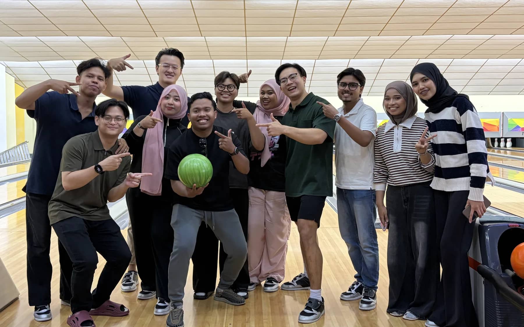 The whole Techwide team posing on the lanes at a bowling night