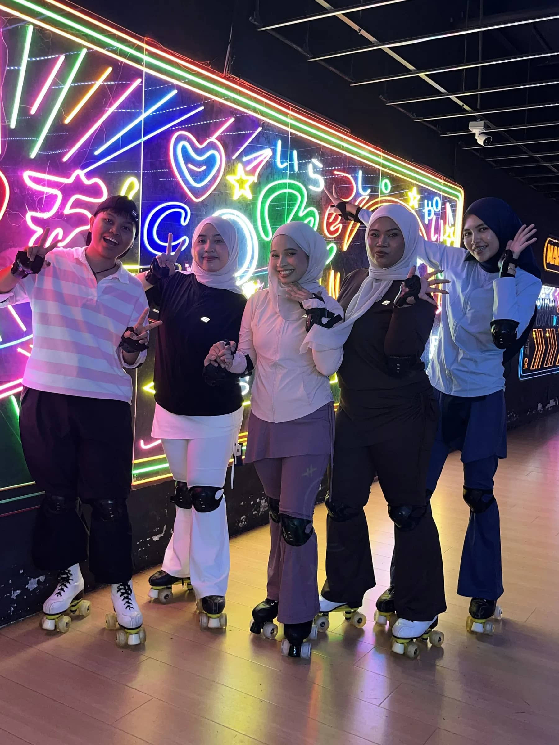 Team roller skating under neon lights